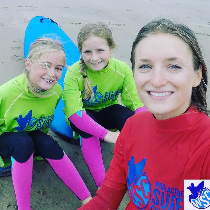 Girls surfing, smiley happy surfers, female surfing learn to surf with Woolacombe Surf Centre