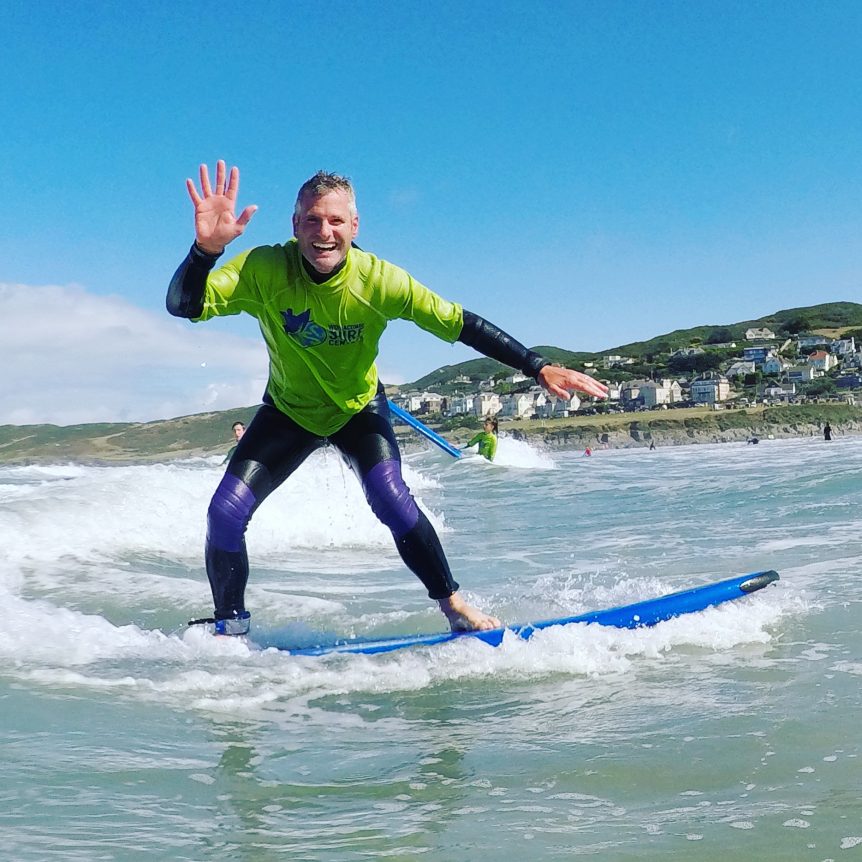 Surfer learning to surf with Woolacombe Surf Centre on Woolacombe Beach North Devon near Croyde, Putsborough, Saunton sands