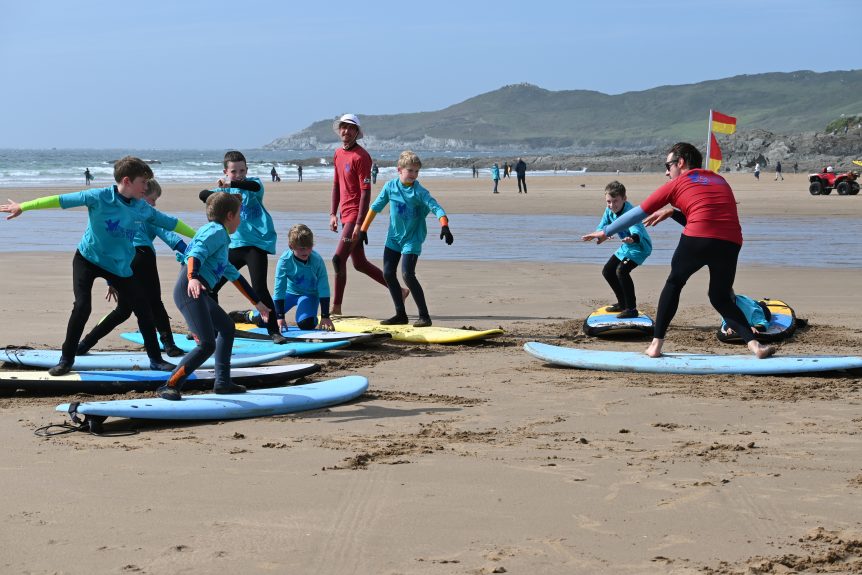 Surfing lessons in the sun, Woolacombe, near Croyde, Putsborough, Saunton, Woolacombe best beach for surf lessons, surf school, North Devon. Surf Centre, Woolacombe Bay