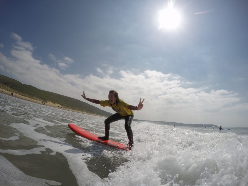 never surfed before on a surf lesson standing up and riding the wave, getting free surfing photos with Woolacombe Surf Centre