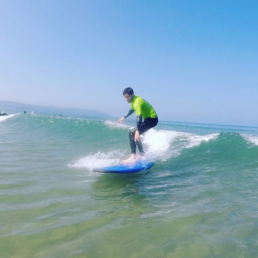 First time surfer, learning to surf with Woolacombe Surf Centre at Woolacombe Bay North Devon, near Croyde and Saunton