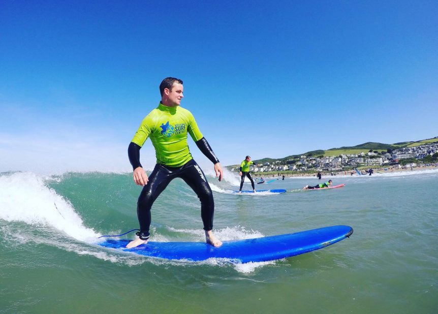 First time surf lesson enjoying the surf at Woolacombe Bay with Woolacombe Surf Centre, best surf school in North Devon