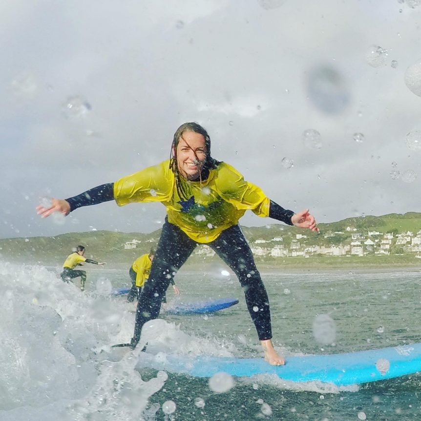 School trip surfing with at Woolacombe Beach with Woolacombe Surf Centre, smiling and having fun!